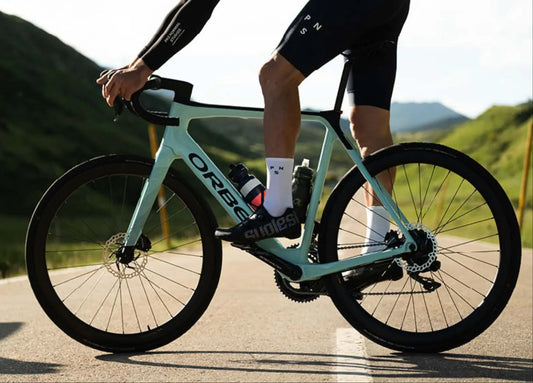 Cyclist riding an Orbea electric road bike on a mountain road