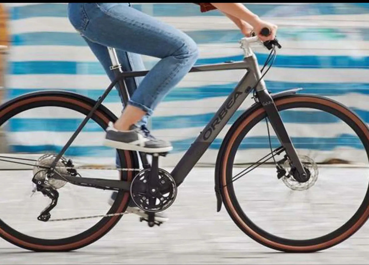 Cyclist riding an Orbea Gain lightweight electric road bike in the city
