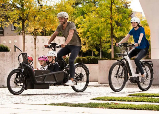 Family riding together in Load 75 cargo ebike and Nevo