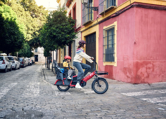 Riese & Müller Multitinker2 Vario red cargo eBike carrying a child in the city