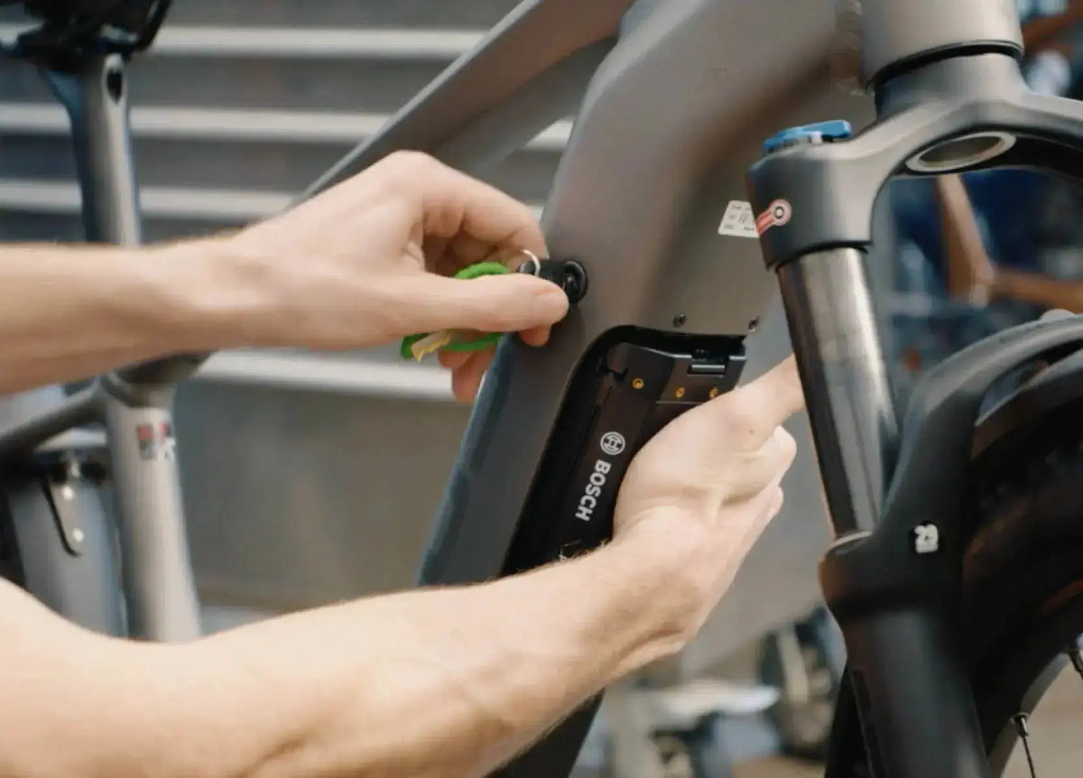 Focus Aventura2 with Bosch Powertube battery being reinserted	Bosch Powertube battery being seated into a Focus Aventura2 e-bike frame with the key inserted