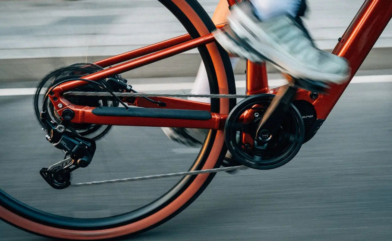 Close-up of an Orbea Carpe 25 E-Bike in Mars Red with a blurred background | Electric Bikes Brisbane
