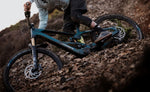 Rider descending a rocky trail on an Orbea Wild LT electric mountain bike, showcasing aggressive enduro eMTB performance.