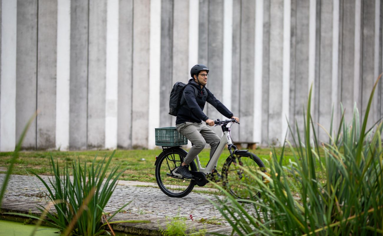 Person riding a Moustache Mardi 27.4 E-Bike  with a basket in an outdoor setting. | Electric Bikes Brisbane