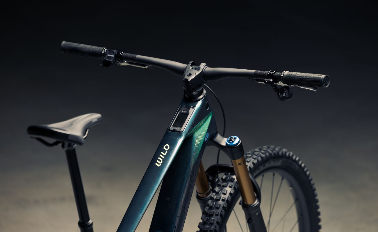 Orbea Wild LT electric mountain bike cockpit showing integrated Avinox display, carbon frame and Fox suspension.