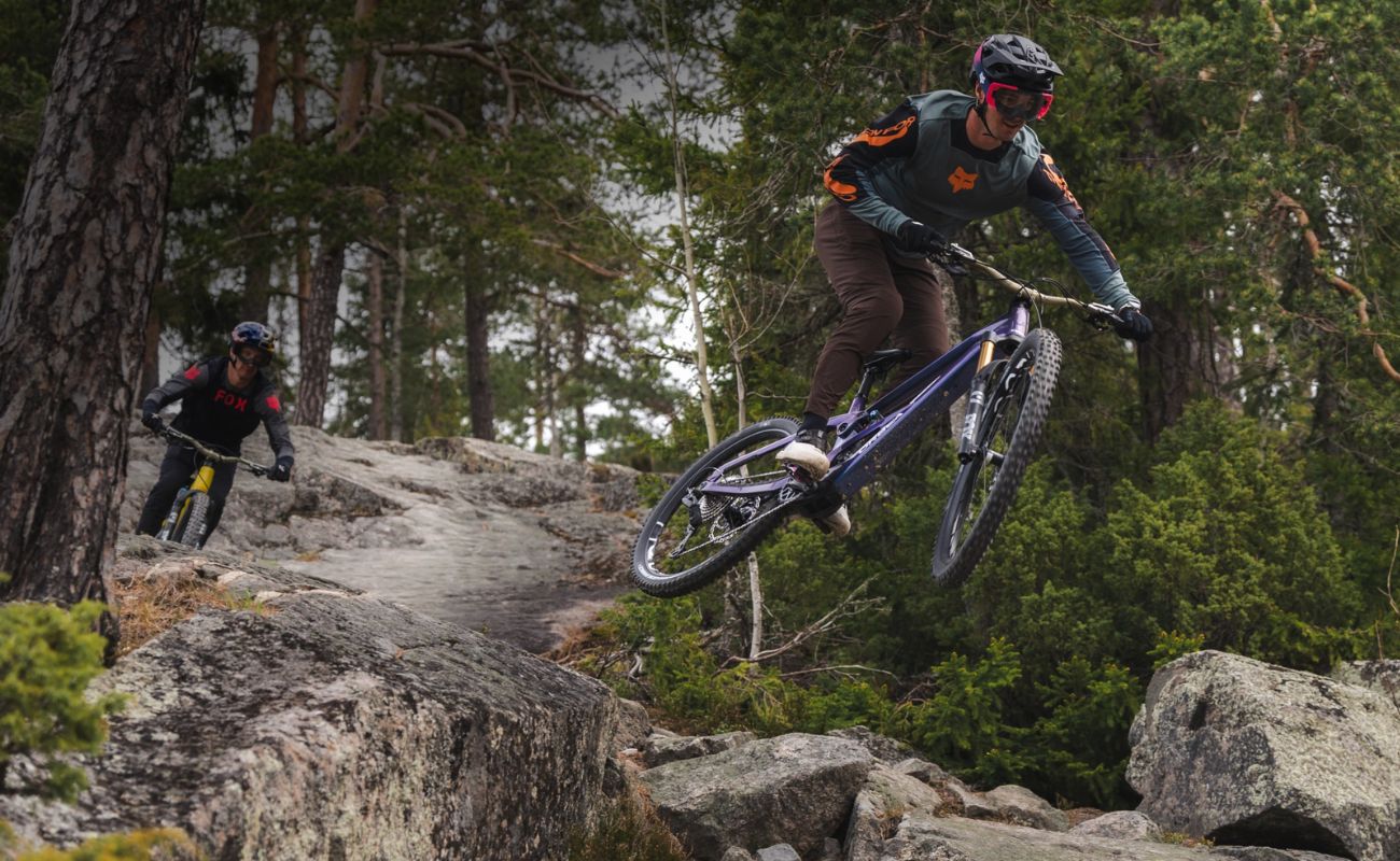 Orbea Wild LT H-Team eMTB rider jumping rocky singletrack trail with Fox Factory suspension and DJI Avinox M2S motor