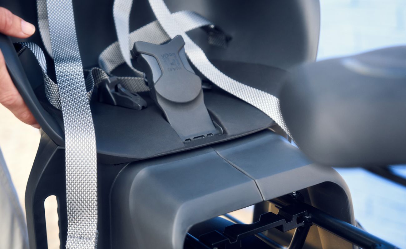Close-up of a MIK child seat being mounted on a Riese & Muller Charger5 Mixte ebike