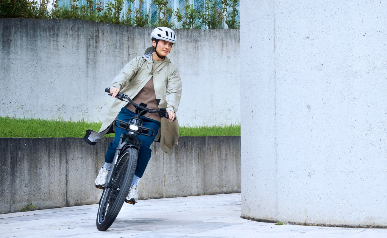 Riese & Müller Homage5 Vario E-Bike rider cornering with front light on