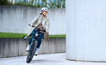 Riese & Müller Homage5 Vario E-Bike rider cornering with front light on
