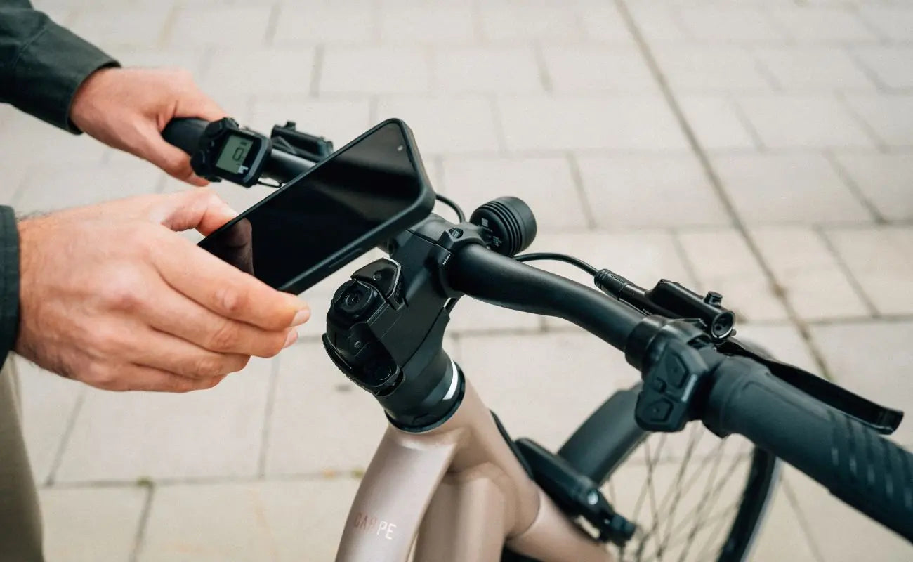 Person using a smartphone mounted on a Carpe 20 Ebike handlebar | Electric Bikes Brisbane
