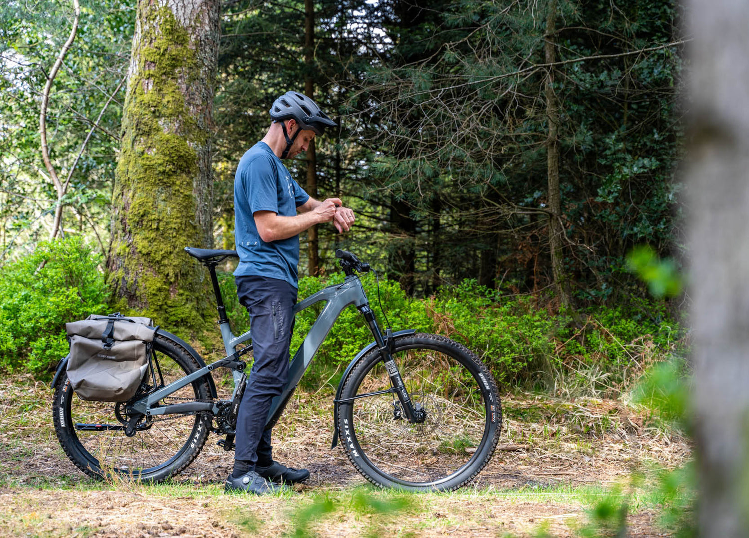 Man riding the Moustache Clutch SUV 150.7 EQ Pinion E-Bike in the forest