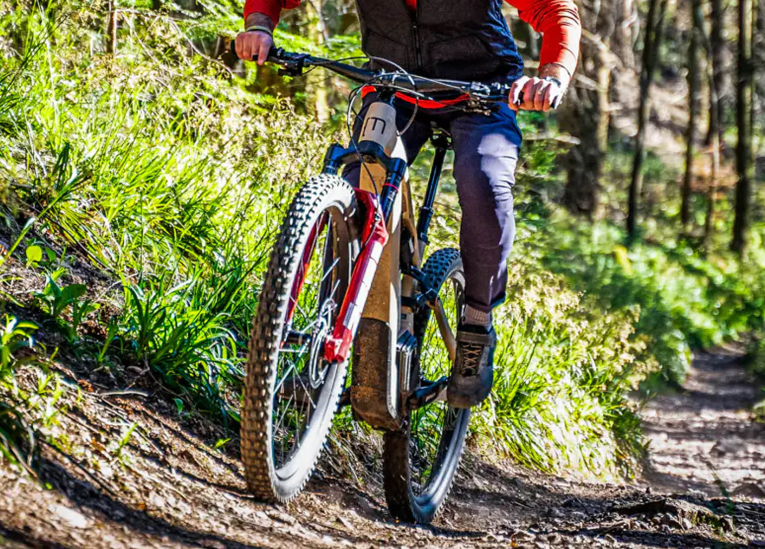 Moustache Clutch 160.9 electric bike climbing on an alpine trail