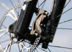 Close-up of a TRP 4-piston brake calliper and rotor on the Focus Jam2 6.9 electric mountain bike