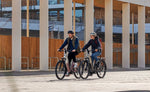 Focus Aventura2 FS 6.8 Wa E-Bike being ridden buy a man and women in a city setting | Electric Bikes Brisbane