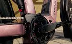 Close-up of a Focus Aventura2 FS 6.8 Wa E-Bike - Nepalsilver with 'Focus' branding on a blurred background | Electric Bikes Brisbane