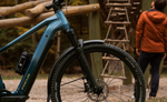 Focus F26 Aventura2 6.8 800Wh E-Bike with a person in an orange jacket in the background