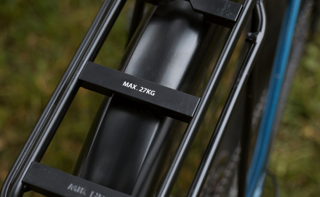Focus F26 Aventura2 6.8 800Wh E-Bike  rack with a weight limit label on a blurred natural background