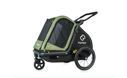 Green and black Hamax Pluto Medium dog trailer in stroller mode, showing mesh panels, push handle and front swivel wheel.
