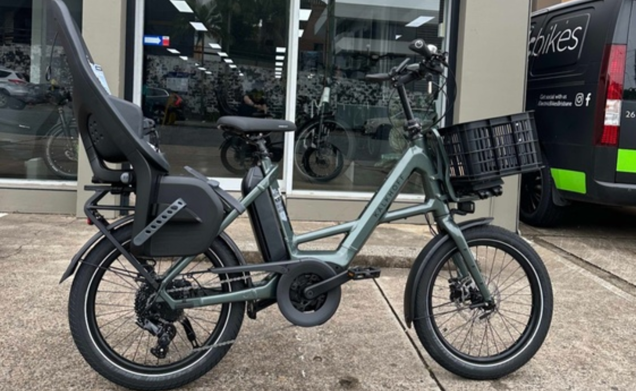 Kalkhoff Endeavour C.B Move+ EBike with a child seat and basket parked outside a store. | Electric Bikes Brisbane