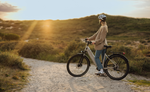 Person riding Kalkhoff Entice 3 Excite Belt Wave EBike on a dirt path with a scenic background | Electric Bikes Brisbane