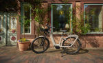 Kalkhoff K26 Image 5+ Advance Wave EBike parked in front of a brick building with decorative windows and plants. | Electric Bikes Brisbane