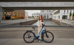 Woman standing next to a Kalkhoff K26 Image L Excite Wave eBike  in an urban setting | Electric Bikes Brisbane