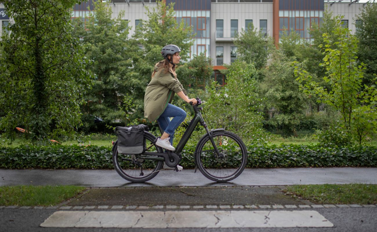 Person riding a Moustache Open Xroad 2 eBike 2026 on a sidewalk | Electric Bikes Brisbane