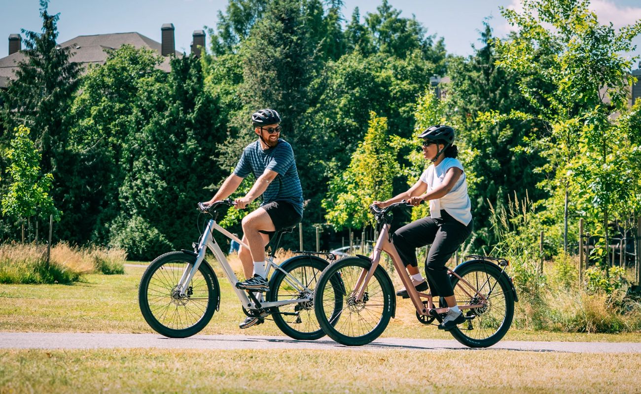 Norco Scene VLT 2 ST E-Bikes being ridden on urban bike path