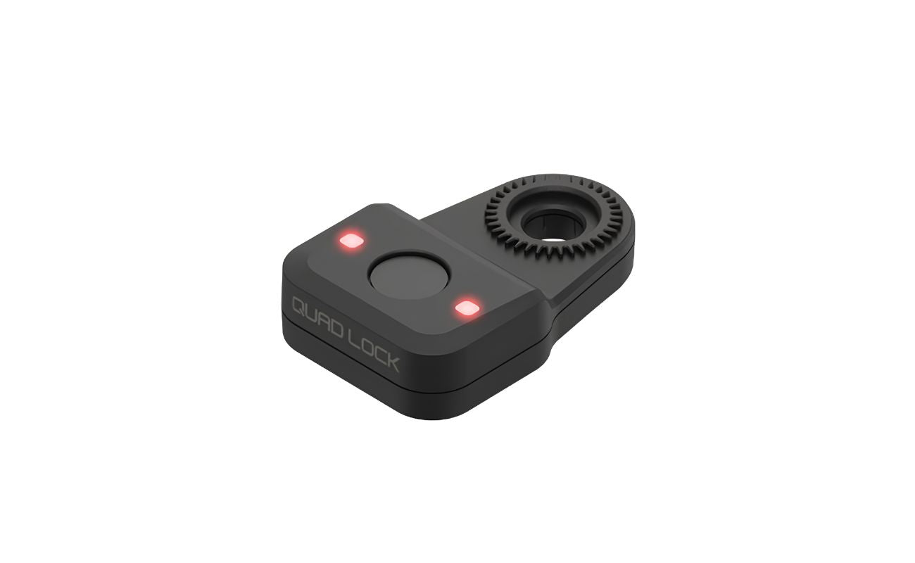 Quad Lock Bike Alarm and Finder showing its fingerprint sensor, two illuminated red LEDs and mounting interface.