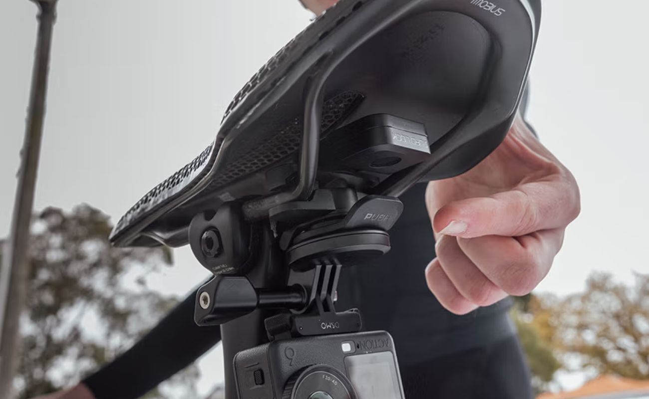 Quad Lock Bike Alarm and Finder fitted beneath a bike saddle with an action camera mounted below.