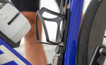 Quad Lock Bottle Cage Adaptor holding a black bottle cage and Bike Alarm and Finder on a blue bike frame.