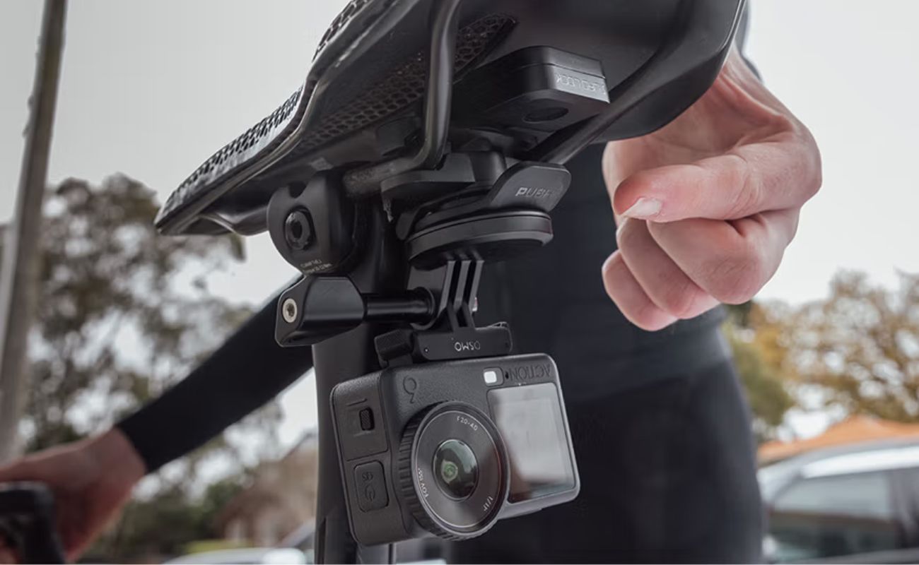 Action camera mounted below a bicycle saddle using the Quad Lock Saddle Rail Adaptor with a lever head and camera adaptor.