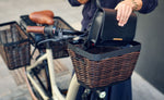 Handbag placed in the optional front basket on an Almond Riese & Müller Swing5 electric bike