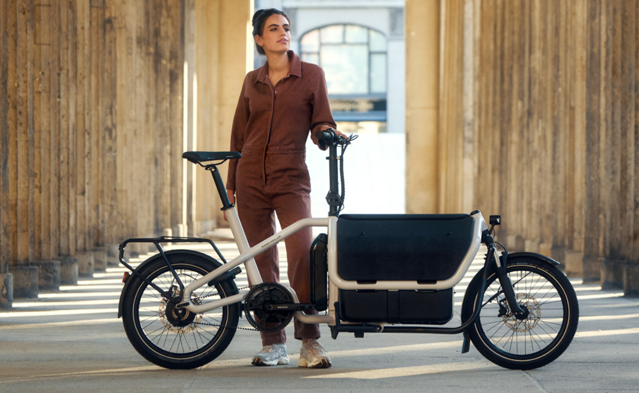 Woman standing next to a Riese & Muller Carrie2 cargo electric bike 