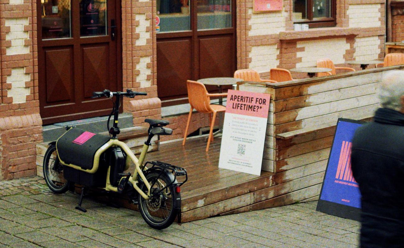 Riese & Muller Carrie electric bike parked outside a cafe or restaurant