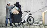 Child sitting and mom closing the passenger cover on the Riese & Muller Multicharger3 Mixte ebike 