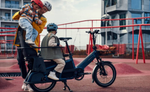 Lifestyle shot with 2 kids about to ride on a Riese & Muller Multitinker electric bike