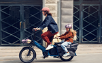 Two people riding a Riese & Muller Multitinker2 Vario Cargo EBike on a city street. | Electric Bikes Brisbane