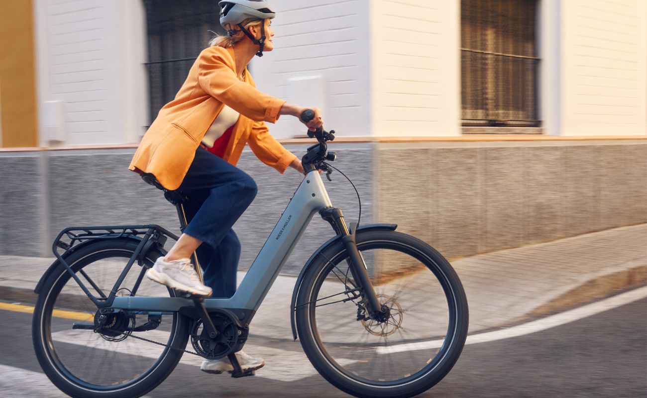 Person riding a Riese & Muller Nevo5 Automatic 800Wh E-Bike on a city street | Electric Bikes Brisbane