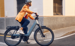 Person riding a Riese & Muller Nevo5 Vario 800Wh EBike on a city street | Electric Bikes Brisbane