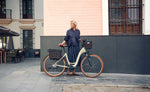 Woman standing next to a Riese & Muller Swing5 Vario E-Bike in an urban setting | Electric Bikes Brisbane