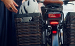 Close-up of a Riese & Muller Swing5 Vario E-Bike with a basket containing a helmet, focusing on the rear section. | Electric Bikes Brisbane