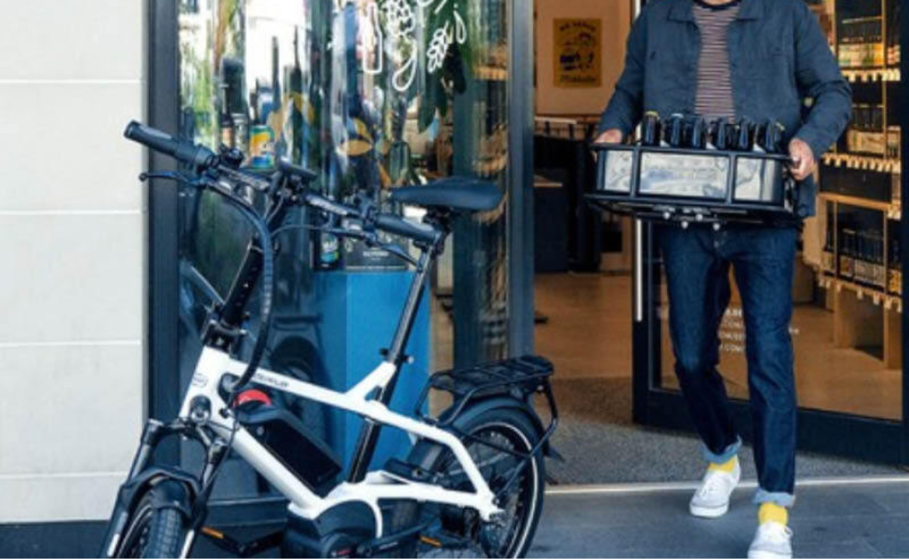 Owner bringing cargo box with crate of bottle about to install it on his Tinker2 ebike | Electric Bikes Brisbane