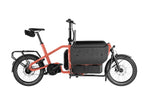 Riese & Müller Carrie2 FAMILY Coral electric cargo bike side view with front cargo box and rear rack, Brisbane